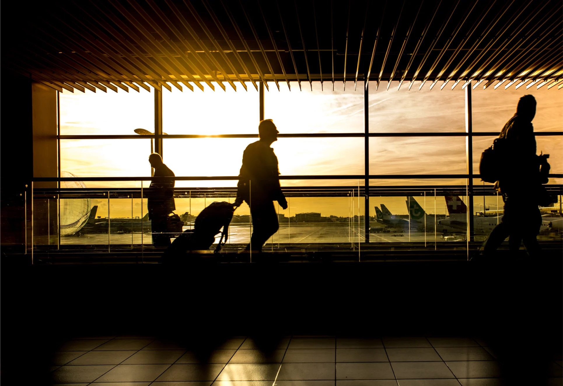 Silhouetted figures walking through Tampa International Airport terminal and baggage, illustrating airport accidents and injuries.