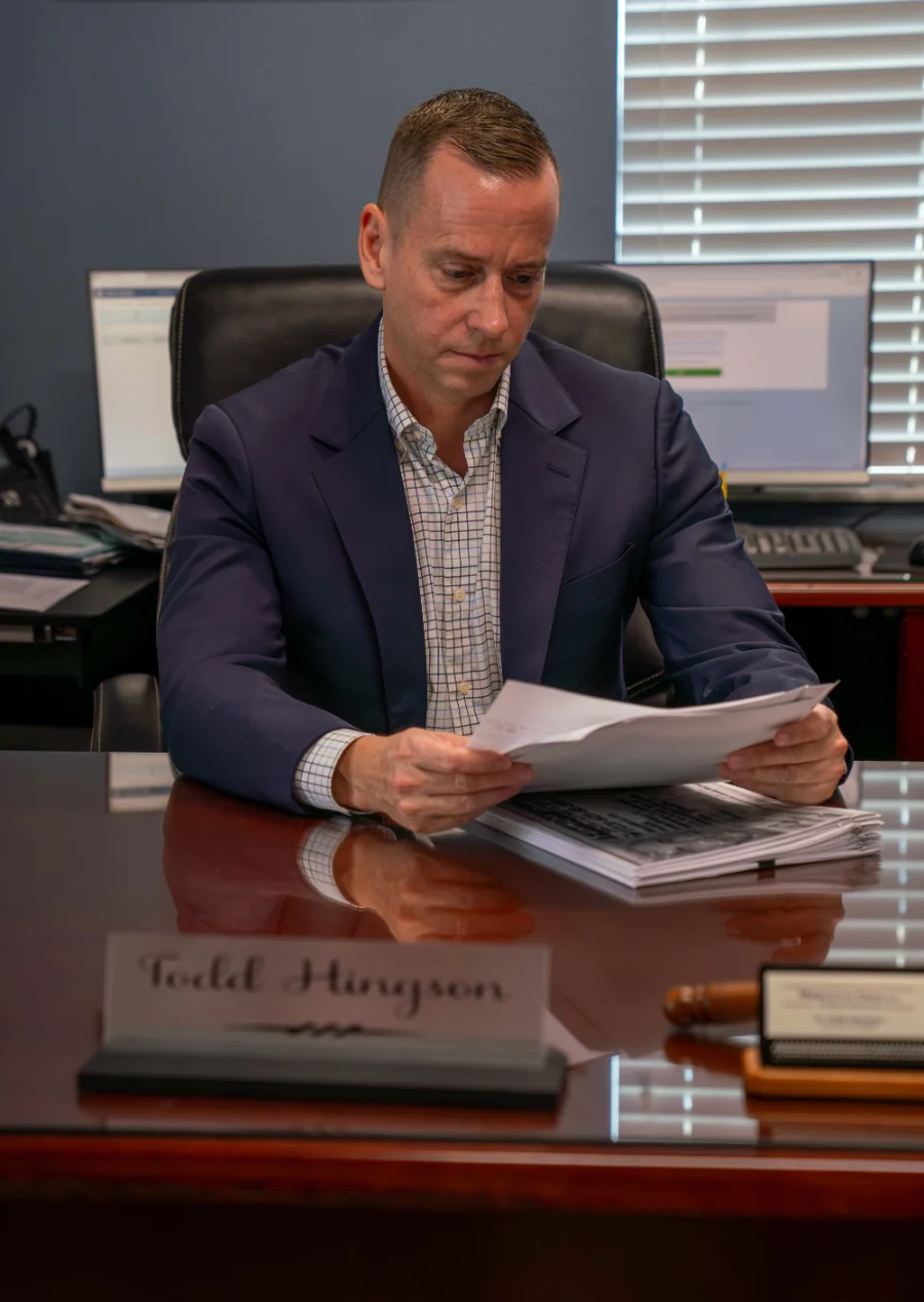 Merricks Law Group attorney Todd Hingston reviewing documents in office setting.