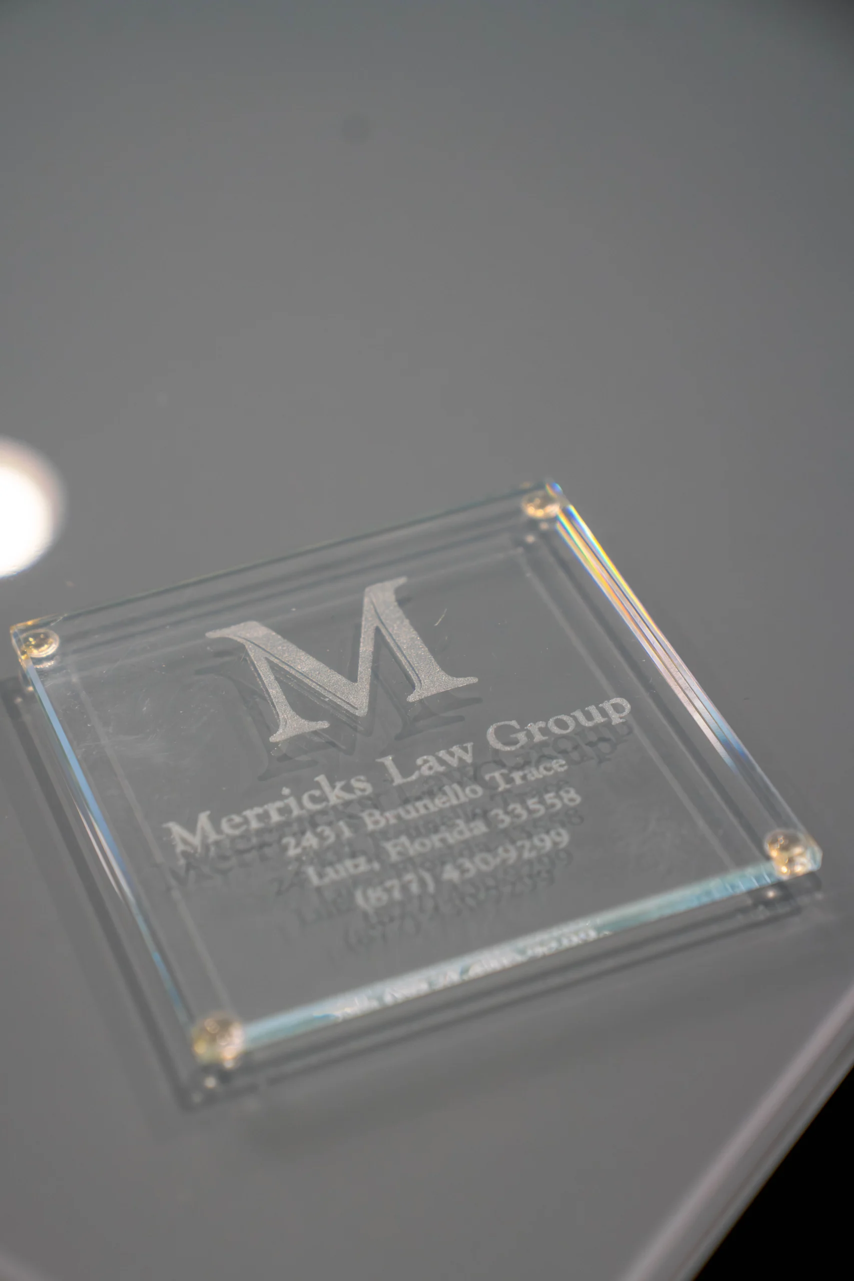 Merricks Law Group office plaque with logo and contact information for airport accident legal representation.