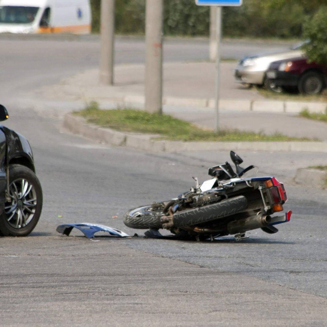 Motorcycle accident scene in Florida roadway and damaged motorcycle after a collision.