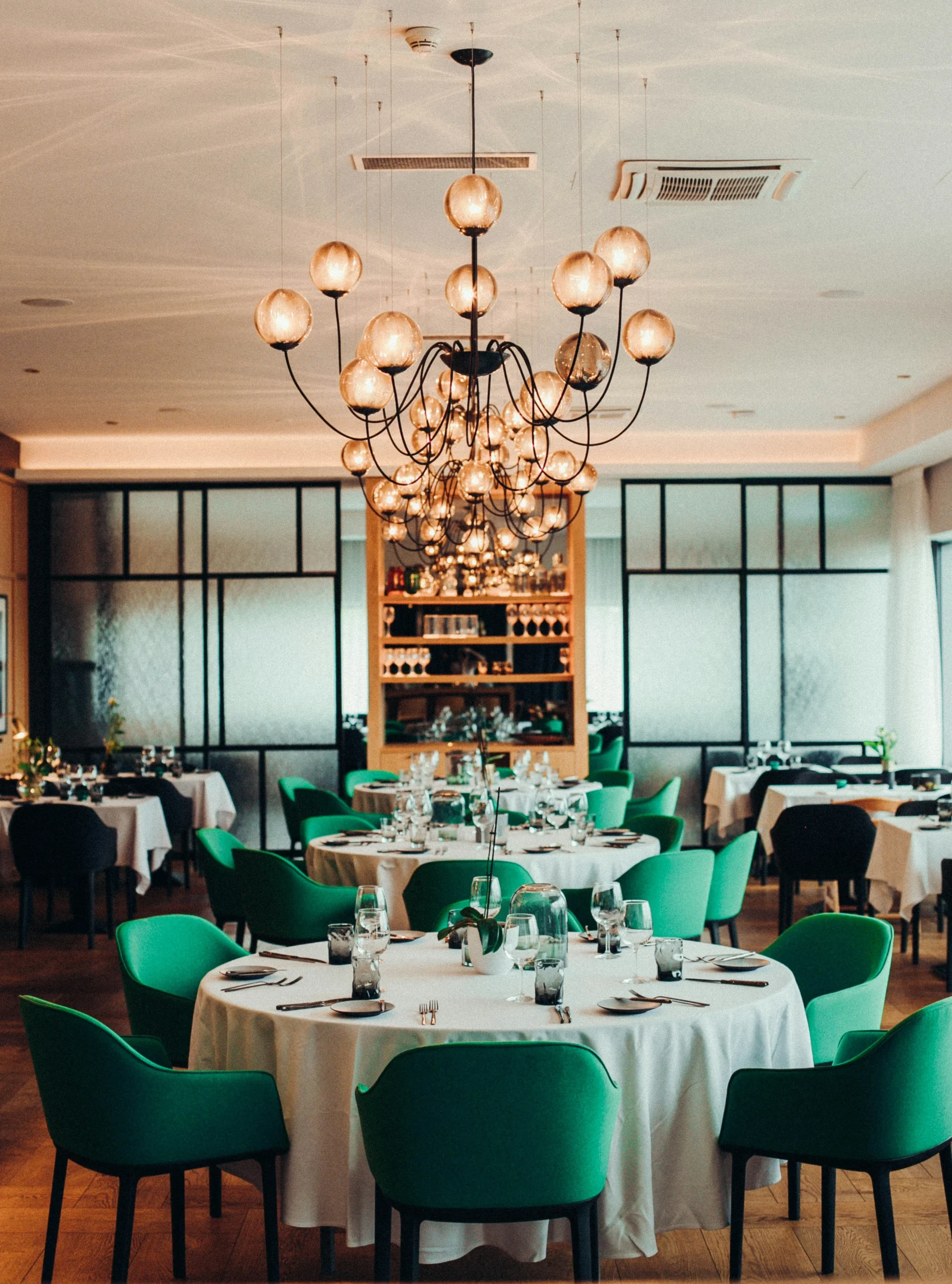 Elegant restaurant interior with tables and chairs, chandelier and bar area, illustrating potential accident locations in Tampa.
