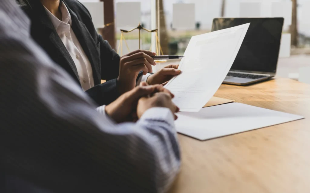 Lawyer and client reviewing legal documents for mass tort or class action claims.