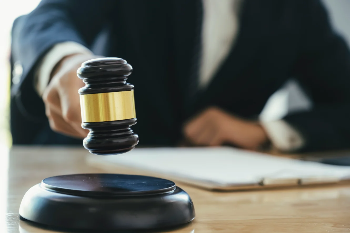 Gavel striking block representing medical malpractice legal claim and compensation.