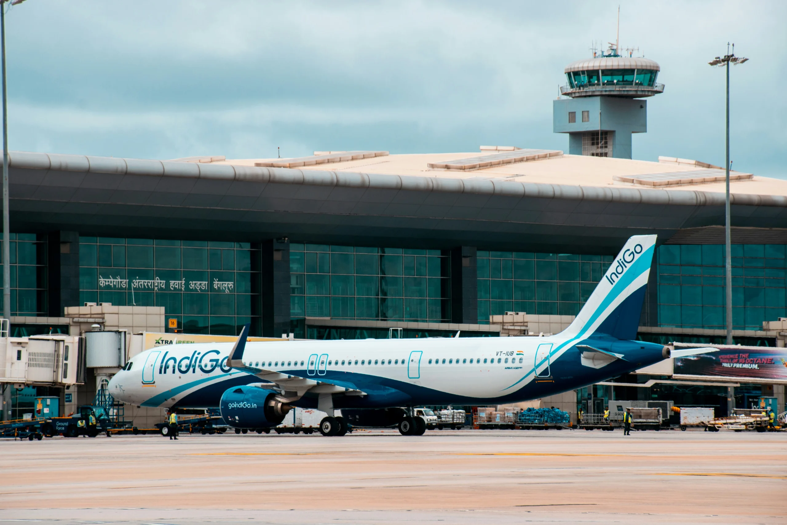 Airport terminal and Indigo airplane illustrating airport accident causes and potential negligence.